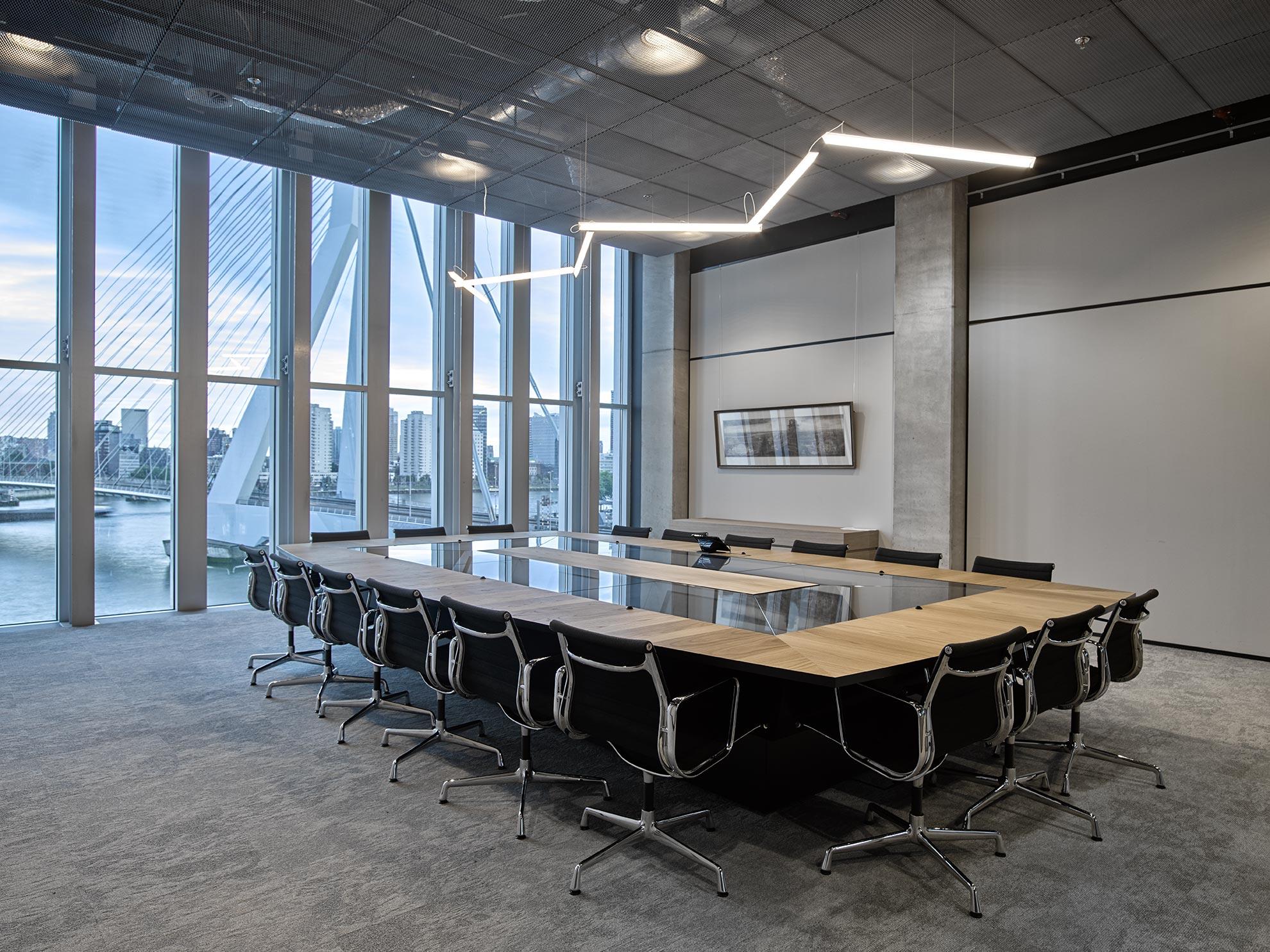 Modern conference room in De Rotterdam building with acoustic ceiling panels and large windows