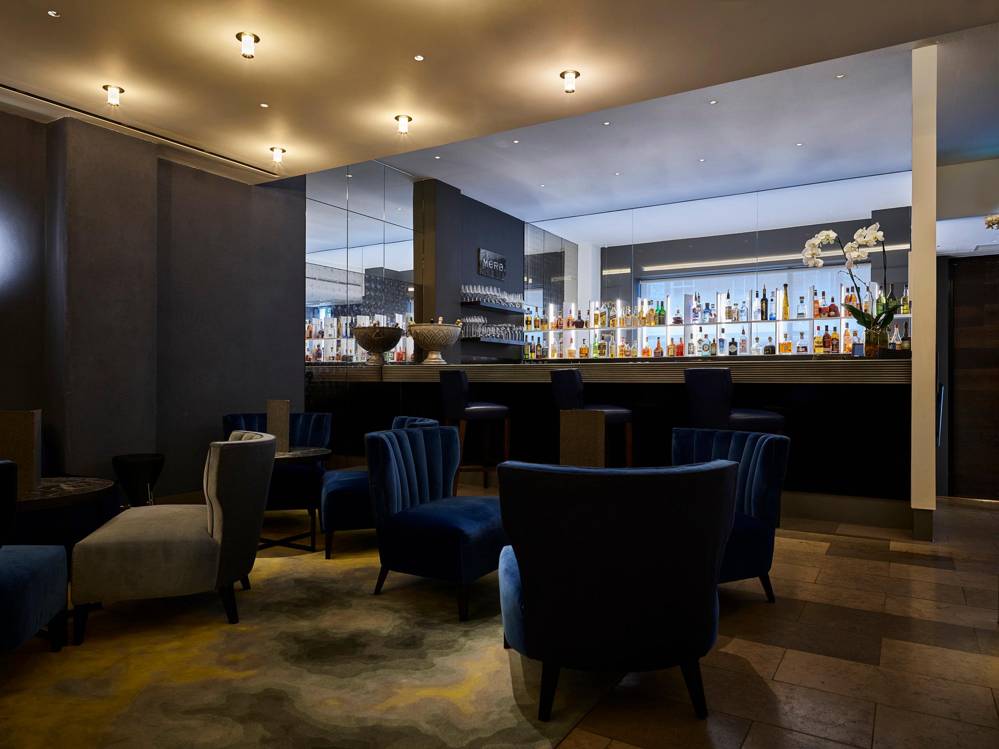 Stylish hotel lounge with Acosorb acoustic ceiling creating a quiet and relaxing atmosphere